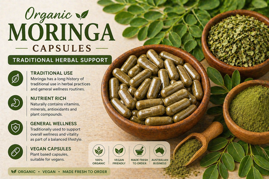 Organic moringa capsules with moringa leaf powder and fresh moringa leaves on natural background